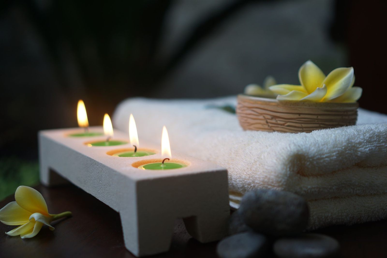Spa candles, folded towels and frangipani flowers for Jeevdhaari wellness membership